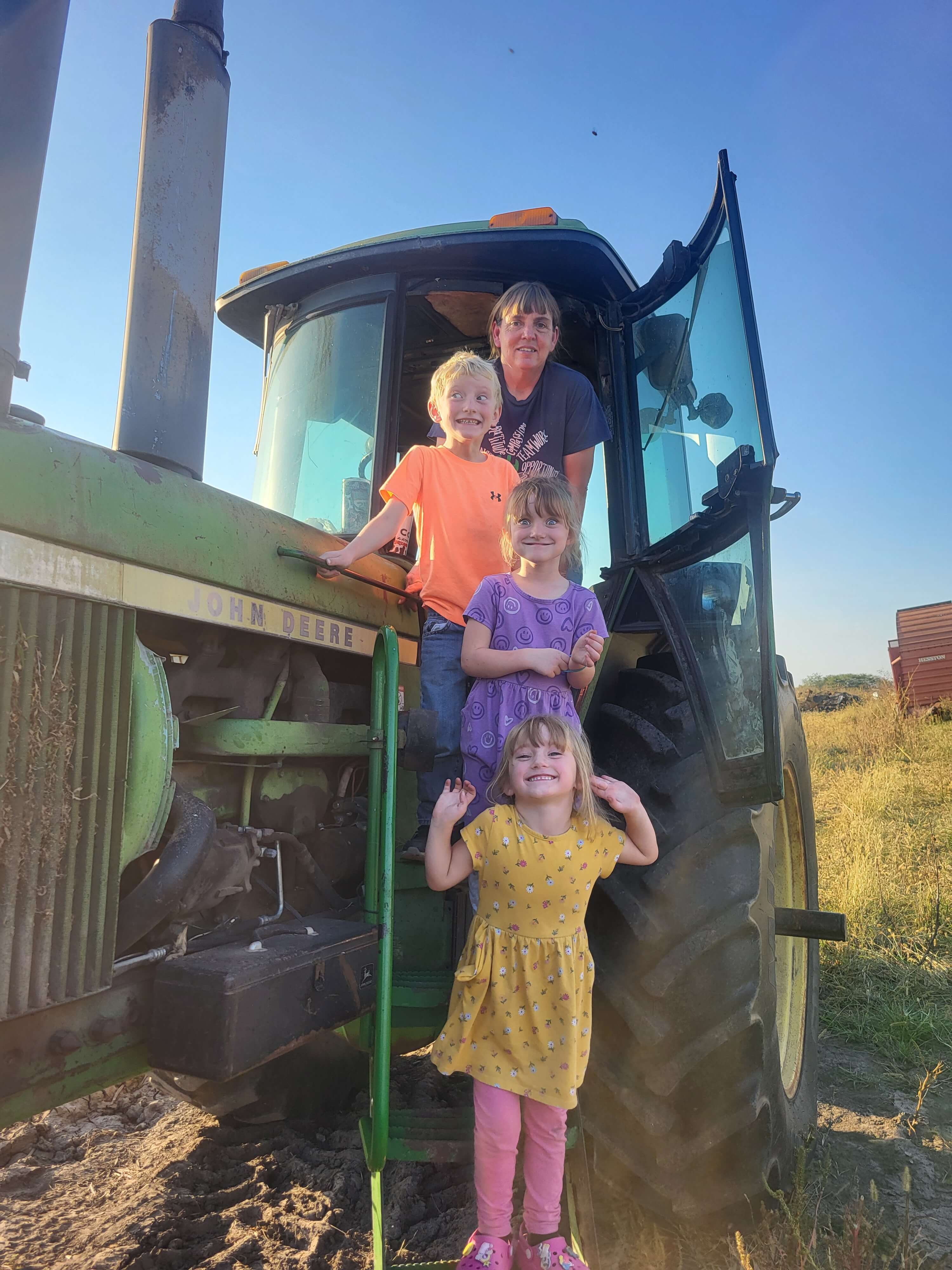 Briar Rose owner and three children by John Deere tractor